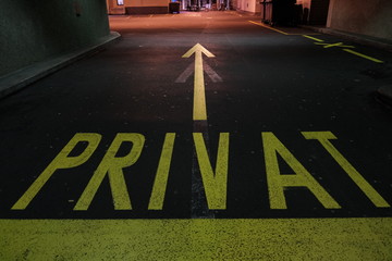 Yellow private sign with line directions for car parking on Zurich street