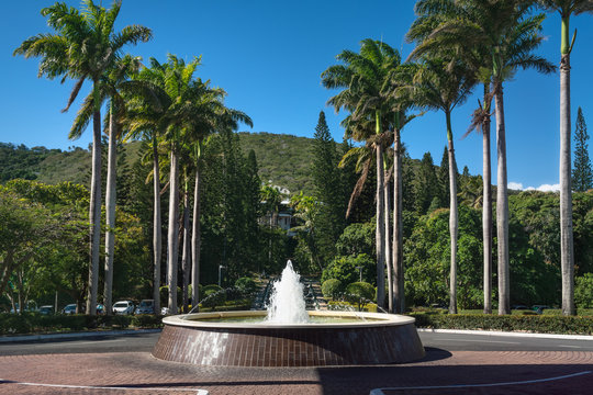 Fountain on a leafy street in Noumea in New Caledonia -an island in  French Polynesia, South Pacific Ocean.