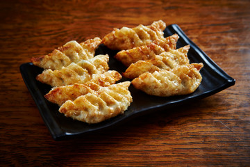 Deep fried dumpling on black plate 