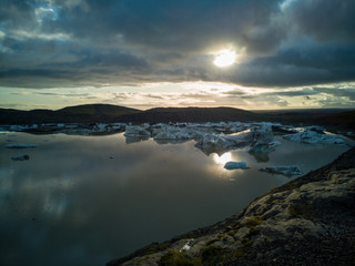 Fototapeta na wymiar Lake with ice blocks at sunset in Iceland