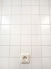 European socket on white tile with lens distortion