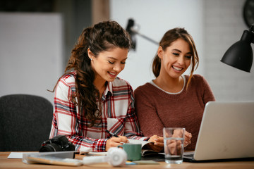 Two friends working together. Colleagues discussing work 