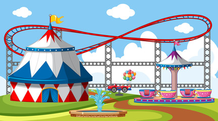 Scene with roller coaster and big circus tent in the park