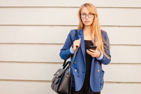 Young stylish business vumen engaged in work on the go.