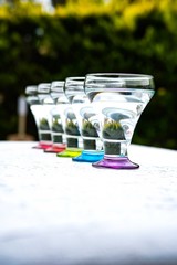 Colorful drinking glasses on white background