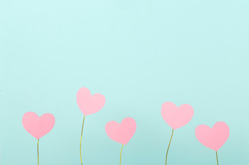 Fototapeta na wymiar Cute little pink hearts against blue background.Empty space for text.Concept of presents for valentine`s day