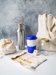 Zero waste travel set from various reusable items on white background. Copy space