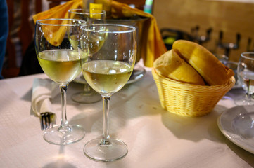 Table served for dinner  with glasses of cold white wine
