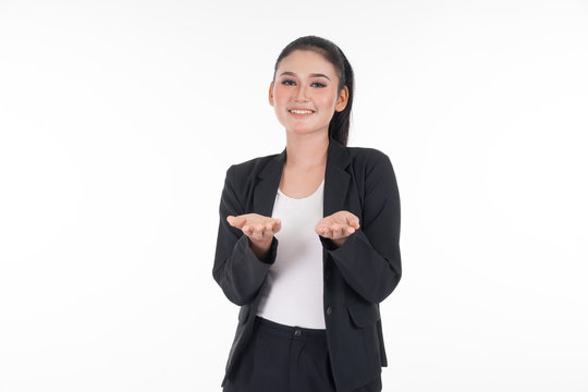 An attractive woman wearing business attire waving her hands in the air navigating on an invisible screen isolated on white. Suitable for image cut out and manipulation works for technology, business.