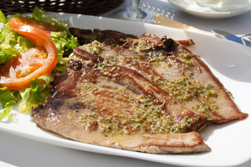 Tasty seafood, grilled tuna fish steaks served on outdoor terrace on Puerto Naos, La Palma, Canary islands, Spain