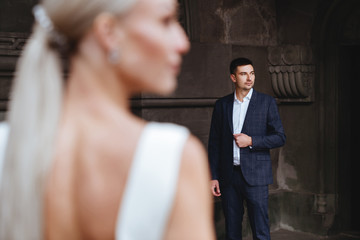 Happy bride and groom near old castle in wedding day
