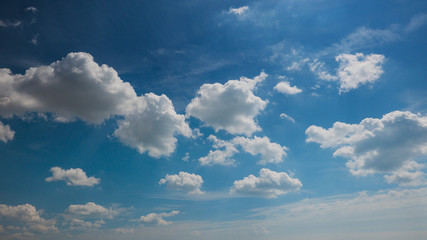 white dramatic clouds floating in the blue sky