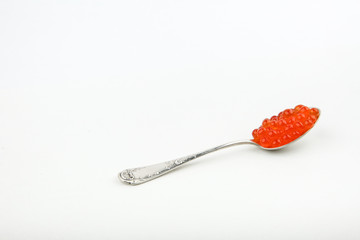 red caviar on a spoon on white background with copy space