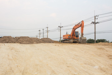 large diesel mechanical excavator digging earth machine at excavation working in road construction