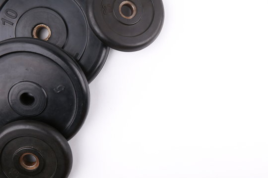 barbell weights on white background flat lay with copy space. backdrop for gym or fitness club