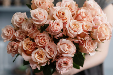 Bright pink spray roses in female hands 