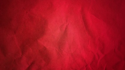 Crumpled red thick paper. Bright beautiful intense blood tint. Texture. Dark vignetting around the...
