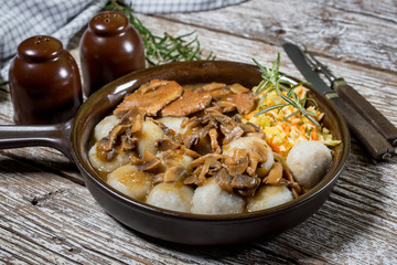 Stewed pork chop in a bright mushroom sauce.