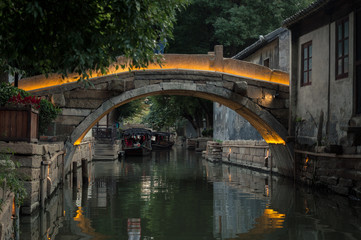 Old stone bridge over the canal in chinese village, Suzhou