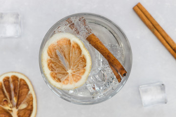 Gin tonic vodka soda cocktail drink in glass with ice cinnamon, top view on white background