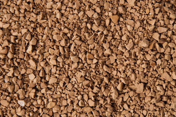 Instant coffee granules close-up, brown background with place for text