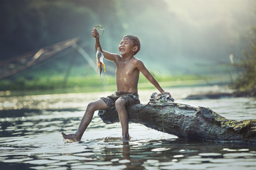 Boy fishing at the river, Countryside of Thailand