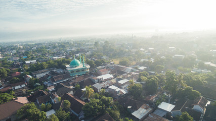 Residential neighborhood subdivision skyline Aerial shot. Top view of house Village from Drone capture. Top-down aerial drone image of a suburb in the midst of summer. Midtown of Indonesia.