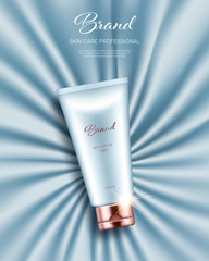 Realistic cream tube with golden lid on light blue smooth satin background. Advertising poster for the promotion of cosmetic skin care premium product