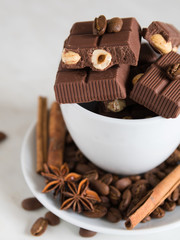 still life, installation, a cup with chocolate, coffee beans, anise and cinnamon sticks on a marble table