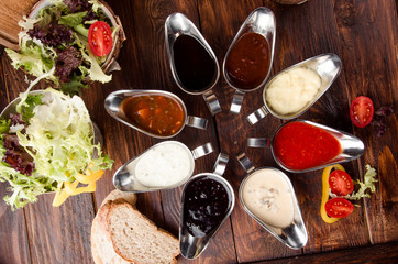 Assorted sauces: ketchup, perigueux, lesser, soy sauce, pesto, berry sauce, bechamel in beautiful aluminum sauceboats