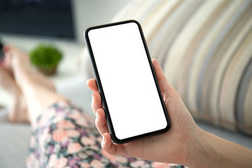 female hand holding phone with isolated screen in the room