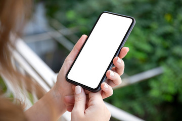 female hands holding phone with isolated screen on background nature