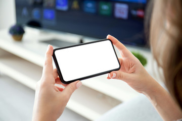 female hands holding horizontally phone with isolated screen