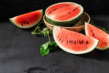 Sliced ripe watermelon on black background