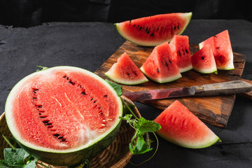 Fresh water melon slices on a wooden cutting board