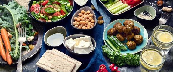 Vegetarian variety dishes on black background.