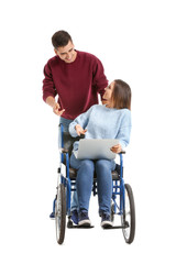 Handicapped young woman with laptop and her husband on white background