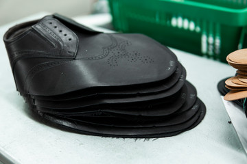 Stitched shoes without soles at the shoe factory. Prepared, bundled leather parts, used in the production of shoes.