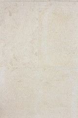 Fototapeta premium light stone wall texture. Space for text. Vertical photo