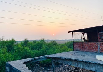 amazing sunset view from a wreaked shop at dumas beach in surat city of india