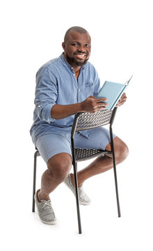 African-American Man Reading Book On White Background