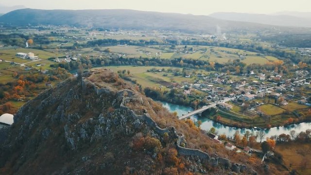 Flight Over Old Ottoman Fortress Spuz. Fortification Stone Walls .Fortress and City Spuz with River Zeta in the Background. Spuska Tvrdjava sa Zidinama.