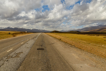 Fototapeta na wymiar asphalt road, Bishkek-Osh highway, Suusamyr valley Kyrgyzstan