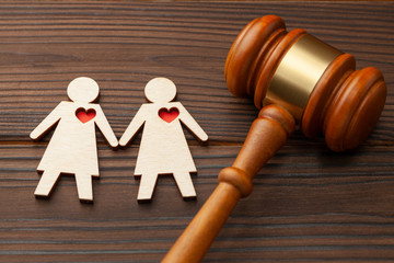 Judge gavel and figure of two lesbian girls holding hands