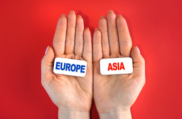 Where to go idea. Europe or Asia concept of choice. Concept with blocks and text in a hands.