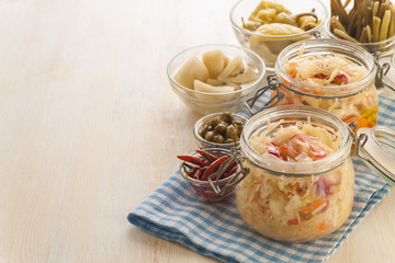 Homemade canned pickled and fermented vegetables for long-term storage.