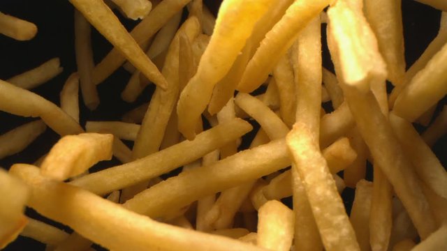 French Fries or Chips Floating in the Air Flying in Slow Motion on Black Background at 1000 fps