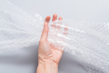 Hand holding packaging material, bubble film