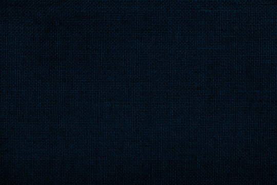 Close up texture of natural weave cloth in dark blue or teal color. Fabric texture of natural cotton or linen textile material. Seamless background.