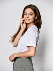 Fototapeta na wymiar beautiful woman office manager posing in a new casual white blouse and classic straight dark skirt